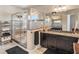 Main bathroom with dual sinks, granite countertops, and a large glass shower enclosure at 6617 Park Strand Dr, Apollo Beach, FL 33572