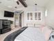 Main bedroom featuring a large window with plantation shutters and decorative fixtures at 6617 Park Strand Dr, Apollo Beach, FL 33572