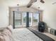 Main bedroom with vaulted ceiling, ceiling fan, large windows, and seating area at 6617 Park Strand Dr, Apollo Beach, FL 33572
