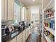 Bright and organized pantry with custom shelving, countertop appliances, and ample storage space at 6617 Park Strand Dr, Apollo Beach, FL 33572