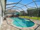 Spacious backyard featuring a pool, screened enclosure, hot tub, and outdoor seating area at 6617 Park Strand Dr, Apollo Beach, FL 33572