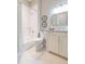 Bright bathroom featuring white marble tiling, a shower-tub combo and a white vanity at 6644 Par Ct, Wesley Chapel, FL 33544