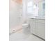 Bright bathroom featuring white marble tiling, a walk-in shower and a white vanity at 6644 Par Ct, Wesley Chapel, FL 33544