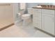 Bathroom featuring white marble floors, a walk-in shower and a white vanity with stone counters at 6644 Par Ct, Wesley Chapel, FL 33544