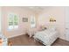 Cozy bedroom featuring hardwood floors, neutral walls, two twin beds, and plantation shutters at 6644 Par Ct, Wesley Chapel, FL 33544