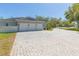 Long paved driveway leads to a three-car garage, offering ample parking at 6644 Par Ct, Wesley Chapel, FL 33544