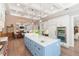 Open kitchen with a blue island, stainless steel appliances, and a seamless flow to the dining area at 6644 Par Ct, Wesley Chapel, FL 33544