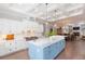 Spacious kitchen featuring a marble island, white cabinetry, modern appliances, and a coffered ceiling at 6644 Par Ct, Wesley Chapel, FL 33544