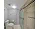 Bathroom featuring a glass shower door, updated fixtures, and a pristine toilet at 700 Starkey Rd # 514, Largo, FL 33771
