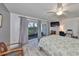 Well-lit bedroom featuring wood-look floors, and sliding glass doors to let in natural light at 700 Starkey Rd # 514, Largo, FL 33771