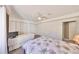 Bright bedroom featuring a floral bedspread, ceiling fan, and ample closet space at 700 Starkey Rd # 514, Largo, FL 33771