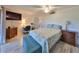 Comfortable bedroom features wood-look floors, a ceiling fan, and a stylish accent bench at 700 Starkey Rd # 514, Largo, FL 33771