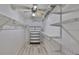 Walk-in closet with custom shelving and storage, featuring a hardwood style floor and a chest of drawers at 700 Starkey Rd # 514, Largo, FL 33771