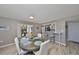 Bright dining room with contemporary floors and a view into the kitchen from the bar top seating area at 700 Starkey Rd # 514, Largo, FL 33771