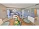 Open-concept dining room featuring updated floors, contemporary décor, and views into the bright kitchen at 700 Starkey Rd # 514, Largo, FL 33771