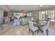 Sun-filled living room featuring modern flooring, a ceiling fan, comfortable seating, and picturesque outdoor views at 700 Starkey Rd # 514, Largo, FL 33771
