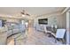 Spacious living area showcasing modern flooring and a partial view into the kitchen and outdoor scenery at 700 Starkey Rd # 514, Largo, FL 33771