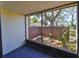 This screened-in patio offers privacy and shade with a wooden fence and flourishing plants at 700 Starkey Rd # 514, Largo, FL 33771