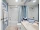 Well-lit bathroom with a shower-tub combination and coordinated blue and white accents at 960 Starkey Rd # 5303, Largo, FL 33771