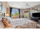 Comfortable bedroom featuring a large window, fan, and balcony access at 960 Starkey Rd # 5303, Largo, FL 33771