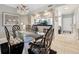 Elegant dining room showcasing a glass-top table, decorative chandelier, and stylish decor at 960 Starkey Rd # 5303, Largo, FL 33771