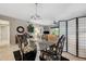Elegant dining room with chandelier and seating for four by a glass table at 960 Starkey Rd # 5303, Largo, FL 33771