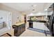 Bright kitchen featuring white cabinetry, dark countertops, a functional island, and modern appliances at 960 Starkey Rd # 5303, Largo, FL 33771