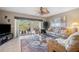 Inviting living room featuring stylish furnishings, a ceiling fan, and a sliding glass door leading to a balcony at 960 Starkey Rd # 5303, Largo, FL 33771