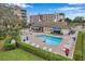 A picturesque swimming pool surrounded by lounge chairs, tables, manicured hedges, and other condo buildings at 960 Starkey Rd # 5303, Largo, FL 33771
