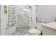 Modern bathroom features sleek gray and white tiled shower with glass door and a matching vanity at 1004 E 22Nd Ave, Tampa, FL 33605