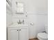 Simple bathroom with a white vanity, modern faucet, toilet, and tiled walls at 1004 E 22Nd Ave, Tampa, FL 33605