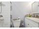 Bathroom features a white toilet and sink with a vanity and modern fixtures at 1004 E 22Nd Ave, Tampa, FL 33605