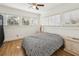 Cozy bedroom with a ceiling fan, hardwood floors, and natural light from multiple windows at 1004 E 22Nd Ave, Tampa, FL 33605