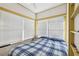 Bright bedroom with a ceiling fan, natural light, and a comfortable bed at 1004 E 22Nd Ave, Tampa, FL 33605