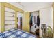 Bedroom showcasing built-in shelves, a closet with hanging clothes, and wood-look flooring at 1004 E 22Nd Ave, Tampa, FL 33605