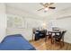 Bright and airy bedroom with hardwood floors, an efficient air conditioning unit, and ample natural light at 1004 E 22Nd Ave, Tampa, FL 33605