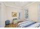 Charming bedroom with wood floors, a large window, and a neutral color scheme at 1004 E 22Nd Ave, Tampa, FL 33605