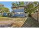 Two-story blue house with white trim, side entry and a mature tree in yard at 1004 E 22Nd Ave, Tampa, FL 33605