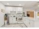 Well-lit kitchen features stylish countertops, modern white cabinetry, and modern stainless-steel appliances at 1004 E 22Nd Ave, Tampa, FL 33605