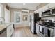 Bright kitchen featuring white cabinets, stainless steel appliances, and a view of the window at 1004 E 22Nd Ave, Tampa, FL 33605