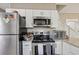 Bright kitchen showcasing stainless steel appliances, white cabinets, and a modern range at 1004 E 22Nd Ave, Tampa, FL 33605