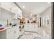 Open kitchen design with white cabinets, stainless steel microwave, and views of the dining area at 1004 E 22Nd Ave, Tampa, FL 33605