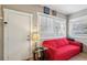 A cozy sitting area with a comfortable red sofa, natural light and convenient access to the entryway at 1004 E 22Nd Ave, Tampa, FL 33605