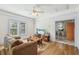 Well-lit living room with hardwood floors, cozy seating, and a view into the kitchen at 1004 E 22Nd Ave, Tampa, FL 33605