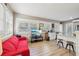 Inviting living room featuring a bright interior, modern flooring, and a cozy red sofa, perfect for relaxing at 1004 E 22Nd Ave, Tampa, FL 33605