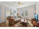 Inviting living room boasts hardwood floors, a soft couch and a view of the television at 1004 E 22Nd Ave, Tampa, FL 33605