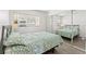 Cozy bedroom featuring a mirrored closet, complemented by light, neutral walls and wood-look floors at 11700 Park Blvd # 202, Seminole, FL 33772