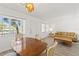 Combined dining and living area with wood-look floors, and neutral decor at 11700 Park Blvd # 202, Seminole, FL 33772