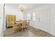 Dining room with wood-look floors, chandelier and large window to let natural light in at 11700 Park Blvd # 202, Seminole, FL 33772