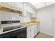 Compact kitchen with white cabinets, and standard appliances at 11700 Park Blvd # 202, Seminole, FL 33772